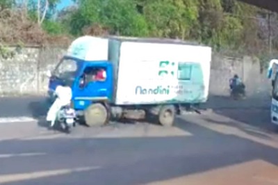 WATCH: Woman Wearing Helmet Narrowly Misses Death After Collision With Truck