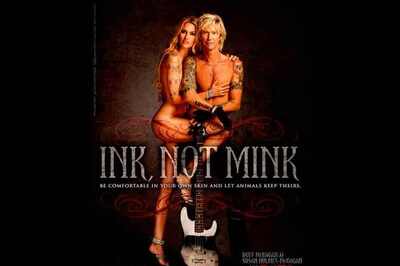 Duff McKagan and Susan Holmes strip for PETA