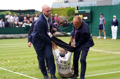 Two Climate Activists Interrupt Wimbledon Match by Scattering Orange Confetti And Puzzle Pieces on Grass